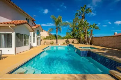 a swimming pool in the backyard of a house at Marbella Lane - Captivating Home w Pool in Rowland Heights