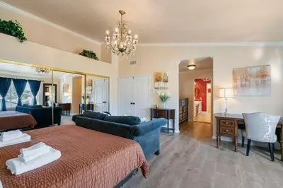 a large living room with a bed and a couch at Marbella Lane - Revitalizing Getaway w Pool in Rowland Heights