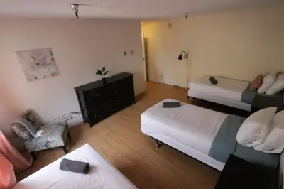 a hotel room with two beds and a chair at 3 beds Apart in Beverly Hills Neighborhood in Los Angeles