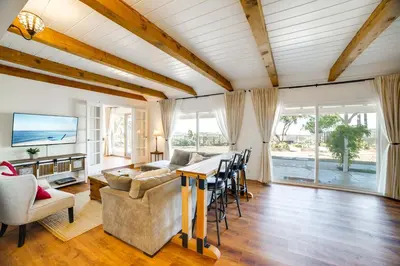 a living room with a table and a couch at Spacious Riverside Farmhouse, Perfectly Located in Riverside