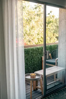 a balcony with a table and a window at Luca's Tree Flat - Los Angeles California in Studio City