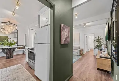 a kitchen with a refrigerator and a living room at Luca's Tree Flat - Los Angeles California in Studio City