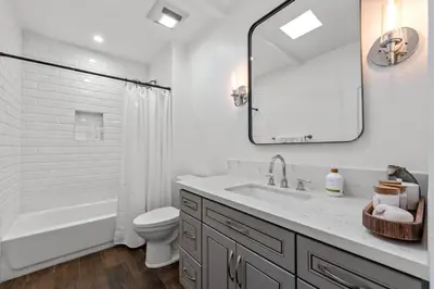 a bathroom with a sink and a toilet and a mirror at Luca's Tree Flat - Los Angeles California in Studio City
