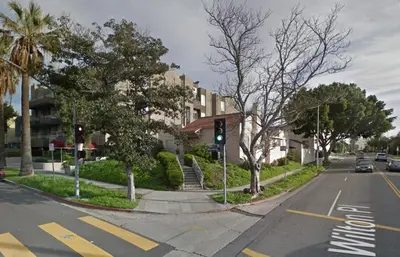 a green traffic light on a city street with buildings at Larchmont 1875 sq ft house 3 bed 2 bathroom in Los Angeles