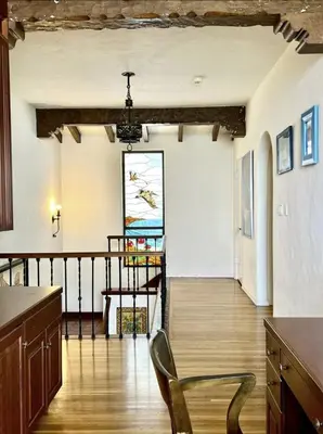 a living room with a chair and a painting on the wall at Villa Porto Marina - Oceanfront Living in Castellammare