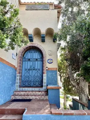 a building with a blue door on the side of it at Villa Porto Marina - Oceanfront Living in Castellammare