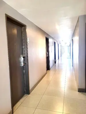 an empty hallway with doors and a tile floor at AVAION HOTEL LAX SoFi STADIUM in Inglewood