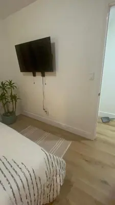 a bedroom with a flat screen tv on the wall at Minimalist Room in Buena Park in Buena Park