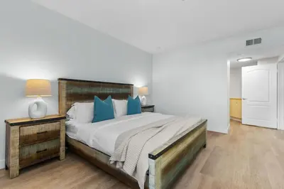 a bedroom with a large bed with blue pillows at The Nautilus Waterfront Retreat Marina View, Pool Sauna Gym Jacuzzi in Los Angeles