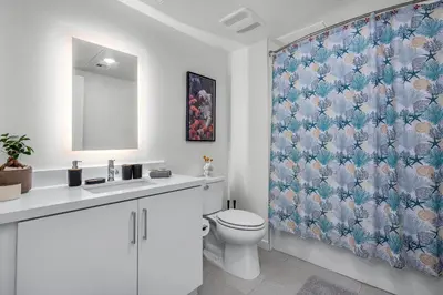 a bathroom with a toilet and a shower curtain at the2 in Los Angeles