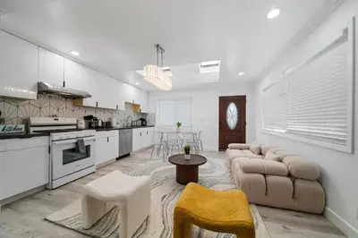 a kitchen and living room with a couch and a table at Marbella Lane - Serene and Pristine 2BR Home in West Covina