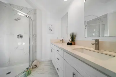 a white bathroom with a sink and a shower at Marbella Lane - Serene and Pristine 2BR Home in West Covina