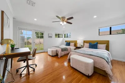 a bedroom with two beds and a desk at Marbella Lane - Serene and Pristine 2BR Home in West Covina