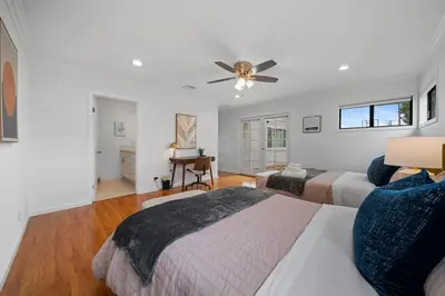a bedroom with two beds and a ceiling fan at Marbella Lane - Serene and Pristine 2BR Home in West Covina