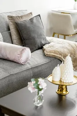 a living room with a grey couch with pillows and a table at Oneluxstay Near Redondo Beach in Redondo Beach