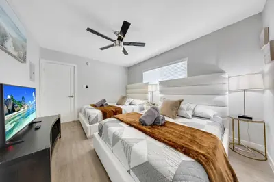 a bedroom with two beds and a flat screen tv at Oneluxstay Near Redondo Beach in Redondo Beach