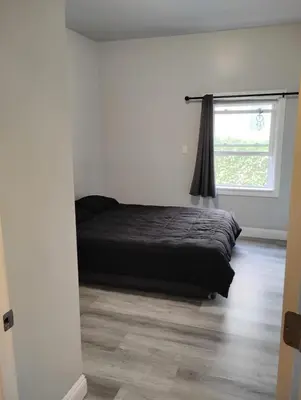 a bed in a white room with a window at Hollywood Comfort Vibe LA in Los Angeles