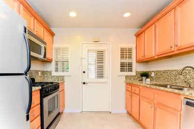a kitchen with wooden cabinets and a refrigerator at Large Room with Private Entrance in Beverly Hills - BRB1 in Los Angeles