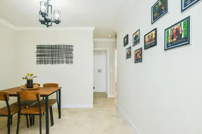 a dining room with a table and some pictures on the wall at Large Room with Private Entrance in Beverly Hills - BRB1 in Los Angeles