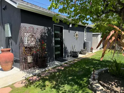 a house with a gate and some plants in a yard at No Ho Casita in North Hollywood
