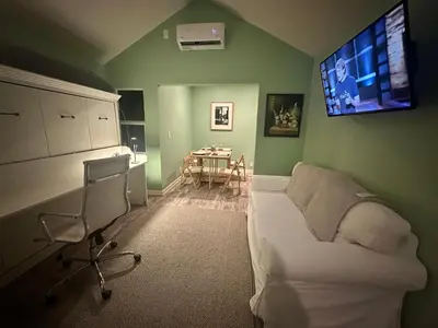 a living room with a couch and a tv on the wall at No Ho Casita in North Hollywood