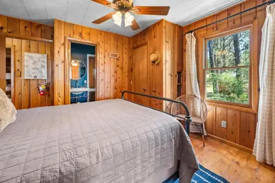 a bedroom with a bed and a ceiling fan at Colibri Cabin - Walk to Lake and Trails in Big Bear Lake