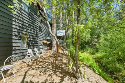 a group of chairs sitting outside of a house at Colibri Cabin - Walk to Lake and Trails in Big Bear Lake