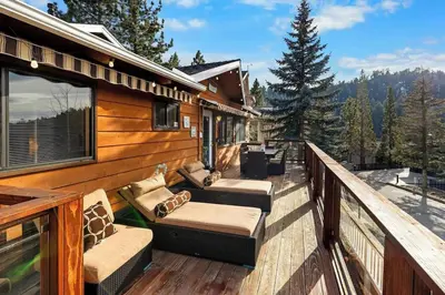 a deck with couches and chairs on a house at Lakeview Retreat - Walk to Lake, Close to Slopes in Big Bear Lake