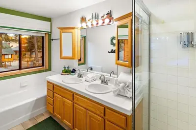 a bathroom with two sinks and a shower at Lakeview Retreat - Walk to Lake, Close to Slopes in Big Bear Lake