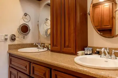 a bathroom with two sinks and a large mirror at Foster’s Cabin - Close to Lake and Slopes in Big Bear City