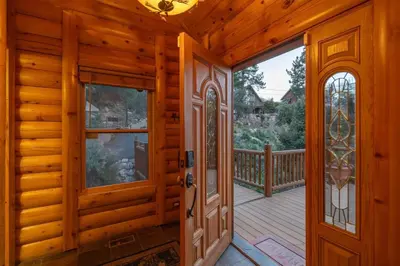 a wooden room with a door and a balcony at Foster’s Cabin - Close to Lake and Slopes in Big Bear City