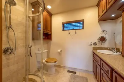 a bathroom with a toilet and a shower and a sink at Foster’s Cabin - Close to Lake and Slopes in Big Bear City