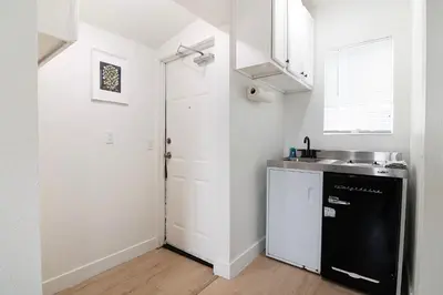 a kitchen with a black refrigerator and a sink at Private Guesthouse Studio Near Echo Park in Los Angeles