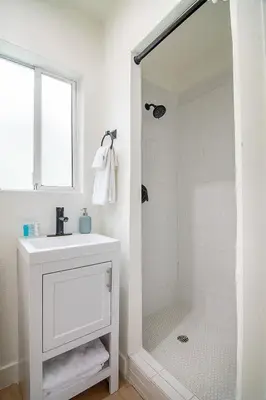 a white bathroom with a sink and a shower at Private Guesthouse Studio Near Echo Park in Los Angeles