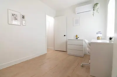 a white room with a desk and a white door at Private Guesthouse Studio Near Echo Park in Los Angeles