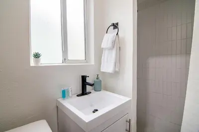 a bathroom with a white sink and a mirror at Private Guesthouse Studio Near Echo Park in Los Angeles