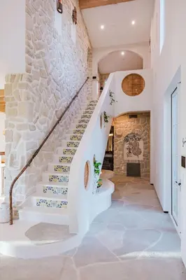 a staircase in a house with a stone wall at Mintcello Estate in Malibu