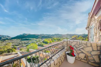 a balcony with potted plants on a stone wall at Mintcello Estate in Malibu