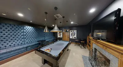 a room with a pool table and a tv at Furnished Studio Apartment in Los Angeles