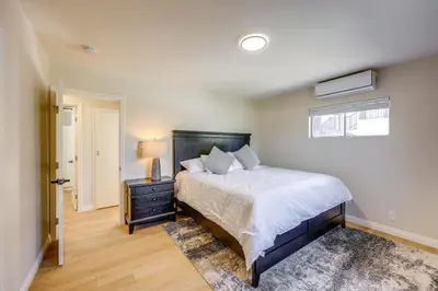 a bedroom with a large bed and a window at Walkable Home Base Near LLUMC and Campus! in Loma Linda