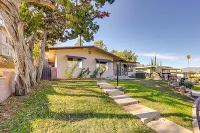 a house with a lawn in front of it at Walkable Home Base Near LLUMC and Campus! in Loma Linda