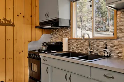 a kitchen with a sink and a stove at Sweet Dream Cabin on Dream Street | Walk to Alpine Slide, Dining, & Big Bear Fun in Big Bear Lake