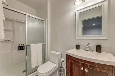 a bathroom with a toilet and a sink and a shower at 5 Mi to Santa Monica Pier and Beach Chic Studio in Los Angeles