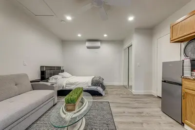 a living room with a couch and a bed at 5 Mi to Santa Monica Pier and Beach Chic Studio in Los Angeles
