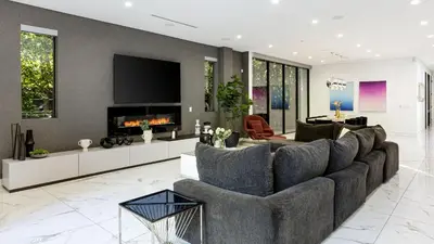 a living room with a couch and a tv at Private LA Retreat w Pool Hot Tub Fire Pit Near Melrose Ave The Martel House by AvantStay in Los Angeles