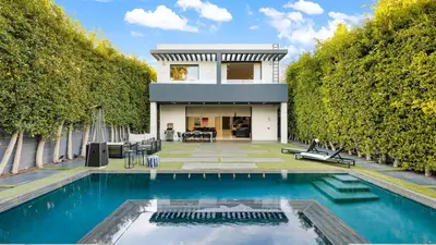 a house with a swimming pool in front of a house at Private LA Retreat w Pool Hot Tub Fire Pit Near Melrose Ave The Martel House by AvantStay in Los Angeles
