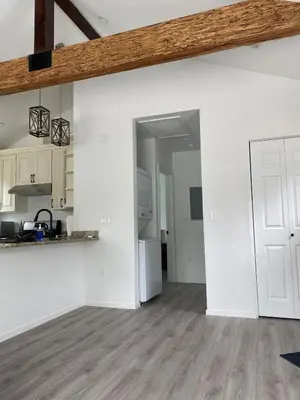 a kitchen with white walls and a wooden ceiling at 530 sq ft Mini House in Walnut in Walnut