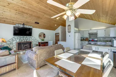 a living room with a ceiling fan and a dining table at 2 Decks! Pet-Friendly Lake Arrowhead Cabin in Lake Arrowhead