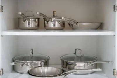 three pots and pans on a shelf in a kitchen at Marbella Lane - Serene & Spacious 3BR Haven in West Covina