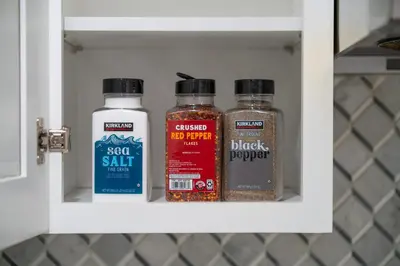 three bottles of spices in a kitchen cabinet at Marbella Lane - Serene & Spacious 3BR Haven in West Covina